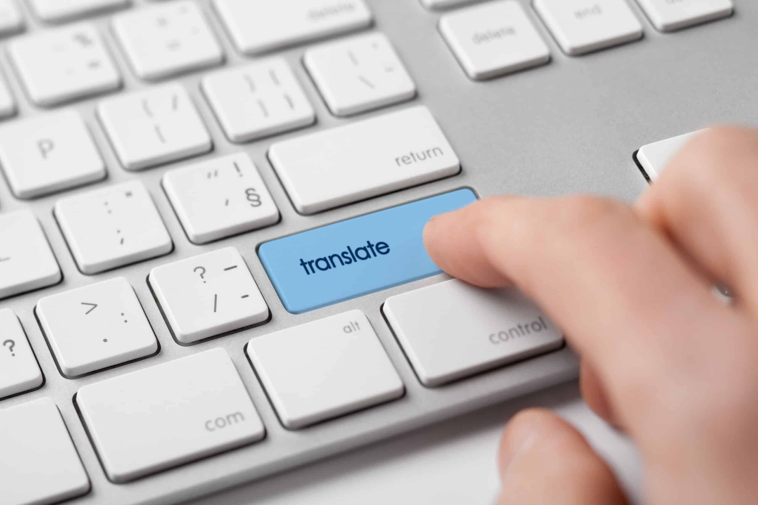A hand on a keyboard, beside a key marked "Translate."