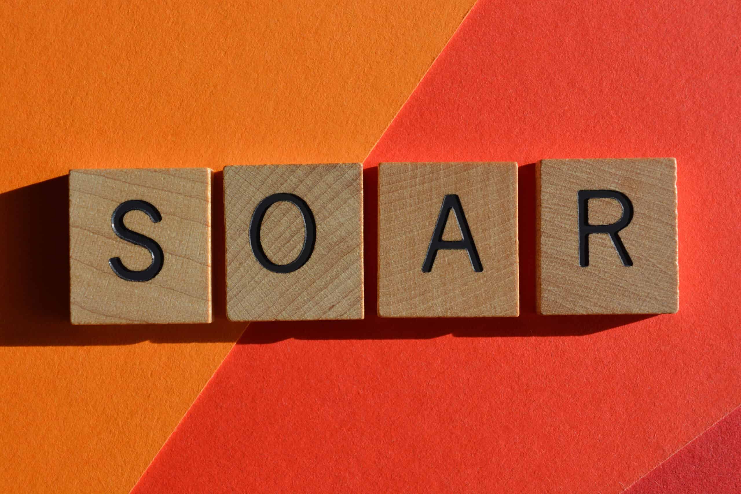 Scrabble letters spell out SOAR on a red and orange background for basically no reason.